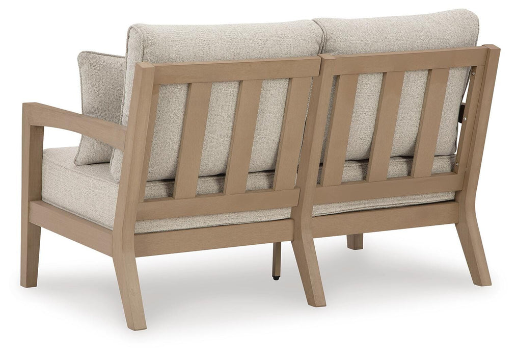 Hallow Creek Outdoor Loveseat with Cushion - Furniture Source (IA) 
