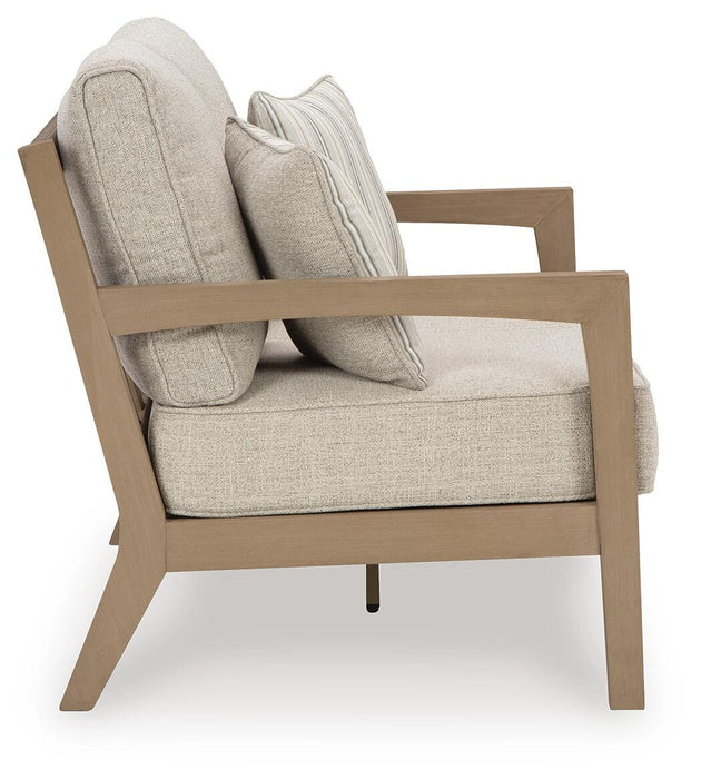 Hallow Creek Outdoor Loveseat with Cushion - Furniture Source (IA) 